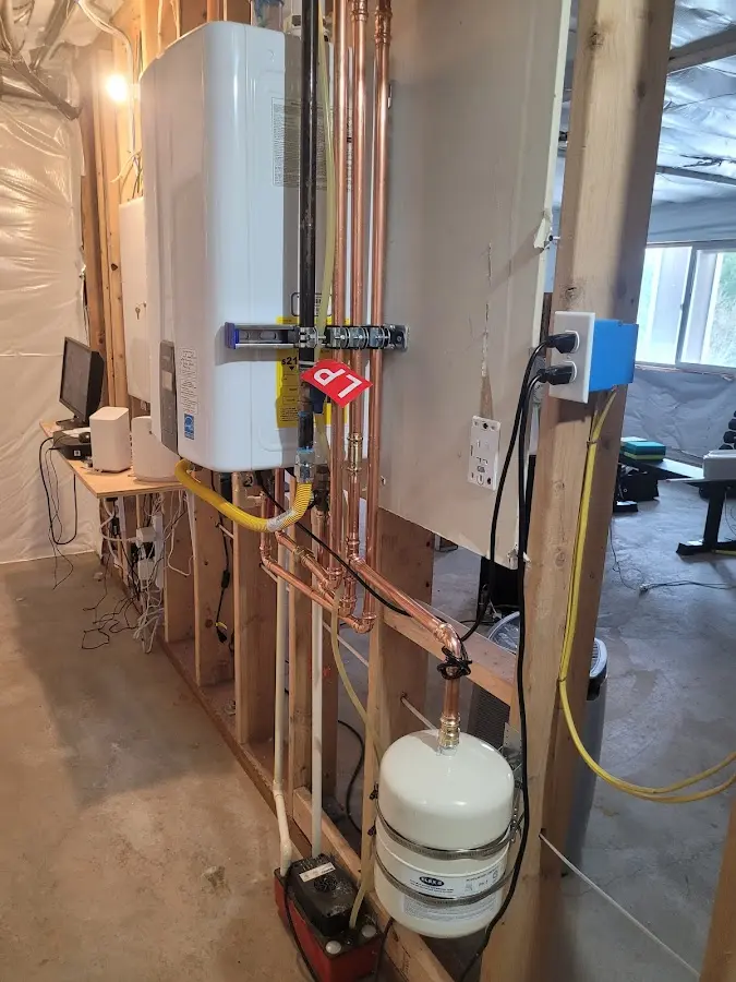 Licensed plumber repairing a kitchen sink in Avon